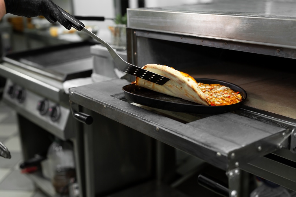 pizza-chef-puts-pizza-oven-bake-oven-restaurant-kitchen.jpg